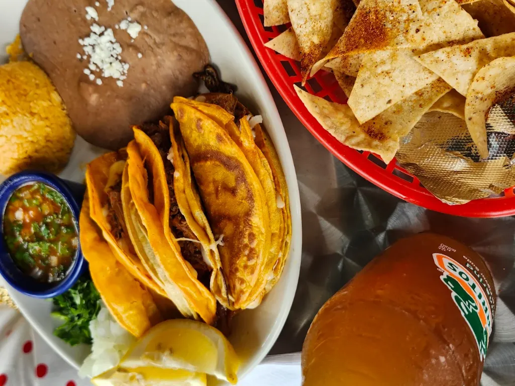 Taco City birria taco plate with rice, beans, and tortilla chips